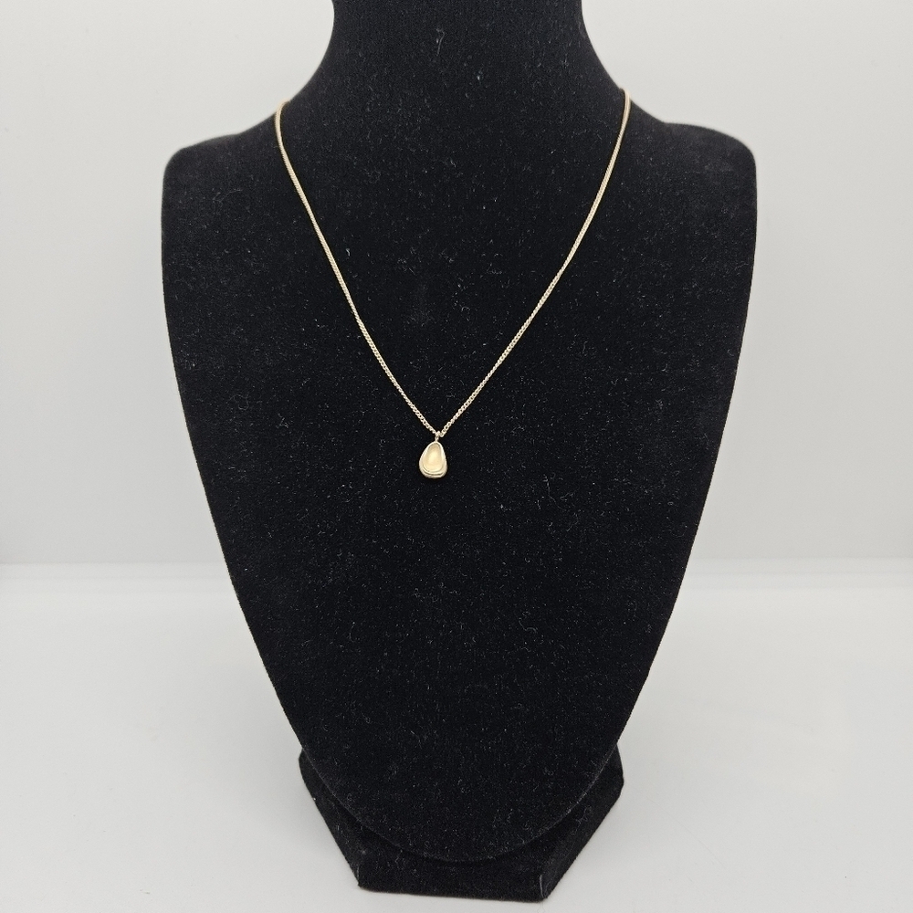 gold tone chain necklace with small matte teardrop pendant